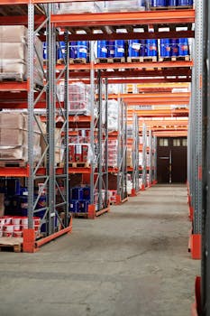 Industrial warehouse interior with organized shelves stacked with packages and goods.